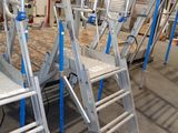 many ladders that are sitting in a room