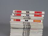 several books stacked on top of each other on a gray surface