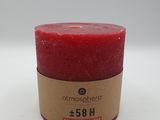 a red candle sitting on top of a white table
