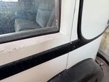 a white truck with a black stripe on the side of it