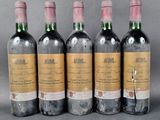 four bottles of wine are lined up in a row