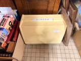 a box with a file of files in it sitting on the floor