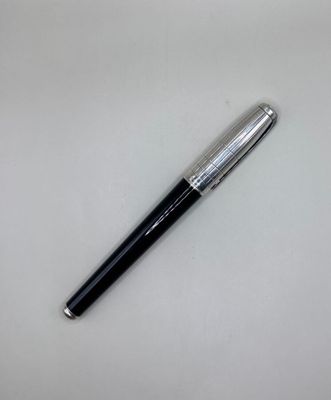 a pen that is laying on a white surface