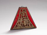 an image of a red and gold triangle shaped object on a white surface