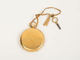 an image of a gold pocket watch with a key hanging from it