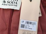 a close up of a red jacket with a label on it