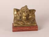 statue of a sleeping woman on a pillow on a marble base
