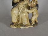 a figurine of a woman holding a child