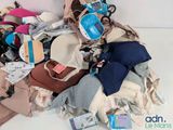 a pile of clothes and other items on the floor