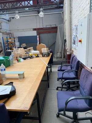 a long table with blue chairs in the middle of a room
