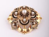 a close up of a gold brooch with pearls and diamonds
