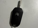 a car key attached to a remote control on a table
