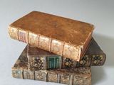 three books stacked on top of each other on a table