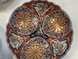 three plates with different designs on them on a white surface