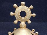 gold plated metal candle holder with a star design on top of it