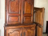 a large wooden cabinet in the corner of a room
