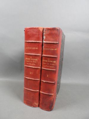 two red books sitting on top of each other on a table
