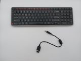 a computer keyboard and a usb cable connected to it