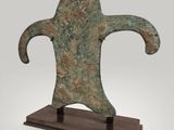 a bronze statue of a man ' s head on a wooden base