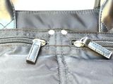 a black purse with a pair of scissors sticking out of it