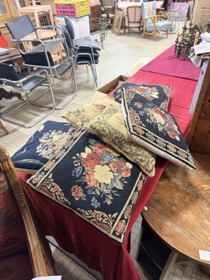 many chairs and tables in a room with a red table cloth on them