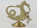 a gold dragon figurine with a chain around it