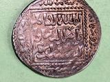 a close up of a coin on a green surface