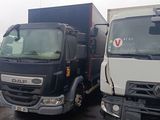 two trucks parked next to each other in a parking lot