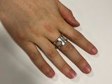 a woman ' s hand with a ring on it