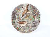 une assiette sur laquelle figurent deux oiseaux sur fond blanc