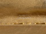 the small metallic bag is gold and has a gold handle