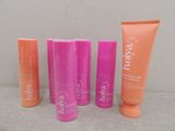 four different types of body lotion products sitting on a table