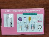 a pink box with a bunch of different items inside of it