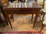 a wooden table with chairs and a rug on the floor