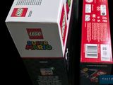 two boxes of legos sitting next to each other on a table