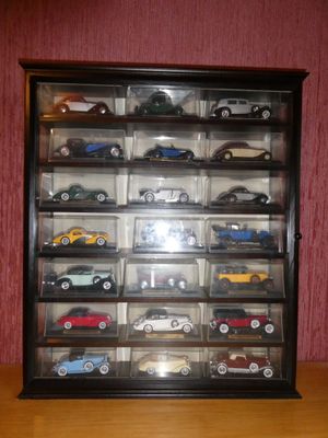 a display case with a lot of toy cars in it