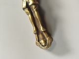 a gold statue of a person holding a cross