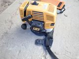 a small yellow and black machine sitting on the ground