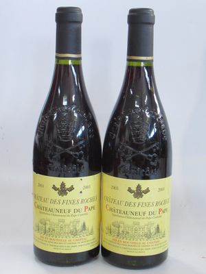 two bottles of red wine sitting next to each other on a table