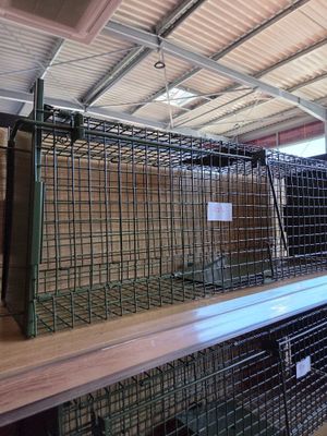 a cage that is on top of a shelf in a room