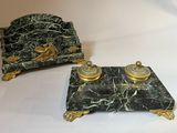 two pieces of green marble with gold decorations on them