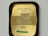 a close up of a gold plate on a white surface