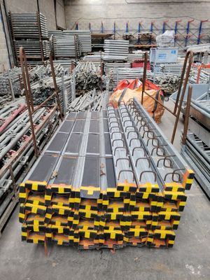 a large pile of steel bars stacked on top of each other in a warehouse