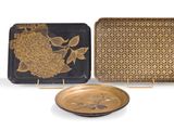 two decorative trays and a plate on a white surface