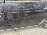 a dirty car that is parked on the side of the road