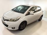 the white toyota yaris is parked in a white room