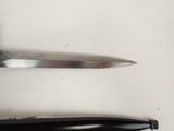 two knives on the table next to each other