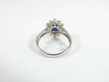 a close up of a diamond and sapphire ring on a white background