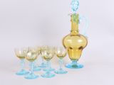 a lot of wine glasses and a decanter on the table