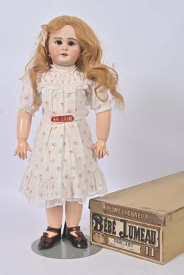 a doll that is standing next to a box